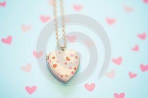 heart-shaped aromatherapy locket against pastel-colored background