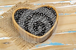 heart shaped black bean bowl on wooden table