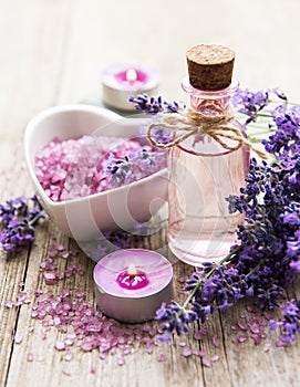 Heart-shaped bowl with sea salt, oil and fresh lavender flowers