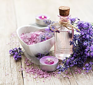 Heart-shaped bowl with sea salt, oil  and fresh lavender flowers