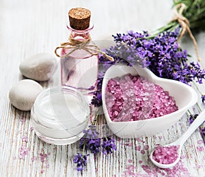 Heart-shaped bowl with sea salt, oil  and fresh lavender flowers