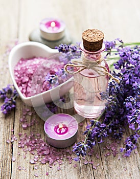 Heart-shaped bowl with sea salt, oil  and fresh lavender flowers