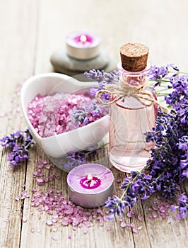 Heart-shaped bowl with sea salt, oil  and fresh lavender flowers