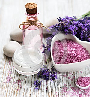 Heart-shaped bowl with sea salt, oil  and fresh lavender flowers