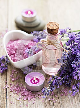 Heart-shaped bowl with sea salt, oil  and fresh lavender flowers