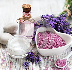 Heart-shaped bowl with sea salt, oil  and fresh lavender flowers