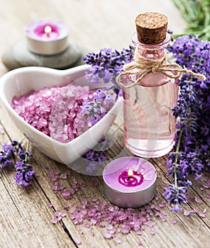 Heart-shaped bowl with sea salt, oil  and fresh lavender flowers