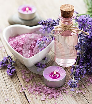 Heart-shaped bowl with sea salt, oil  and fresh lavender flowers