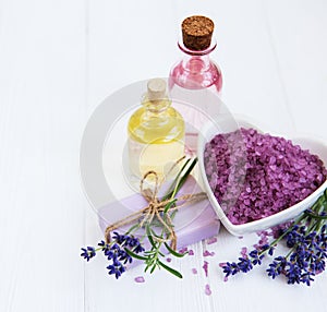 Heart-shaped bowl with sea salt, soap and fresh lavender flowers