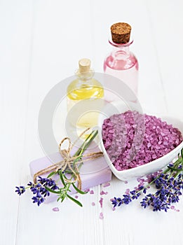 Heart-shaped bowl with sea salt, soap and fresh lavender flowers