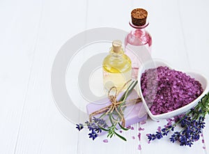 Heart-shaped bowl with sea salt, soap and fresh lavender flowers