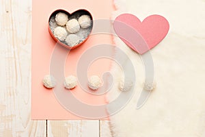 Heart shaped box with coconut balls and paper heart,