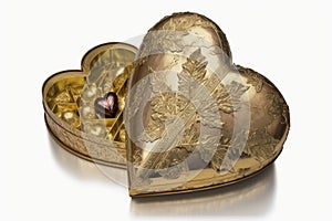 heart-shaped box filled with handmade truffles and confections, wrapped in gold or silver foils