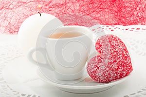 Heart-shaped cake with a cup of green tea