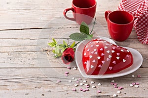 Heart shaped cake for Valentine`s Day or mother`s day on wooden table