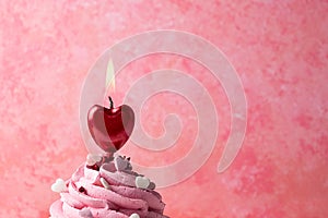 Heart shaped candle burning on cupcake, valentine`s day concept