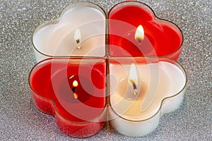 Heart shaped candle burning red and White