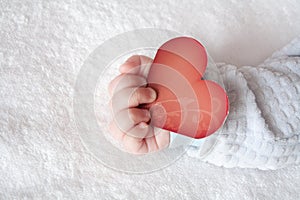 Heart shaped card in baby hand