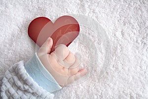 Heart shaped card in baby hand