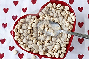 Heart shaped cereal in a red heart shaped bow