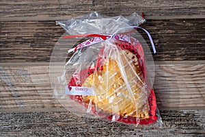 Heart-shaped cherry hand-pie wrapped in cellophane