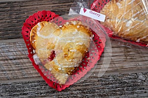 Heart-shaped cherry hand-pie wrapped in cellophane