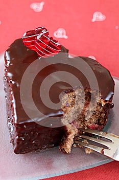 Heart shaped chocolate cake with a bite