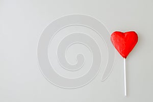 Heart shaped chocolate candy with red wrappings und photo