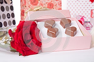 Heart Shaped Chocolate Love in pink gift box and Roses Valentines Day