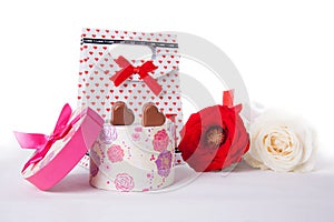 Heart Shaped Chocolate Love in pink gift box and Roses Valentines Day