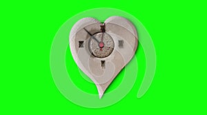 Heart-shaped clock on a green background