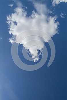 Heart shaped cloud on blue sky