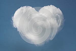 Heart shaped cloud in the blue sky with space for text, valentines day background