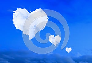 Heart-shaped clouds blue sky.