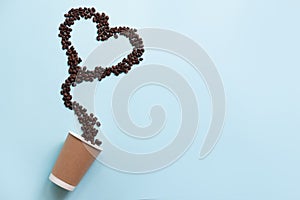 Heart shaped coffee beans and paper cup isolated on blue background.