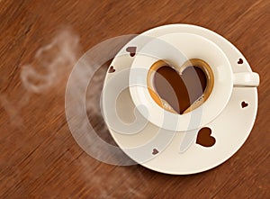 heart - shaped coffee Cup with coffee beans around