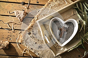 Heart-shaped container with ashes and wooden cross top view