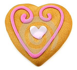 Heart shaped cookie with a pink frosting decoratio