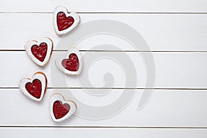 Heart shaped cookies with jam for Valentines day on white wooden background