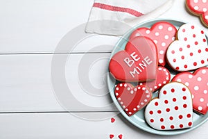 Heart shaped cookies on white wooden table, flat lay with space for text. Valentine`s day treat