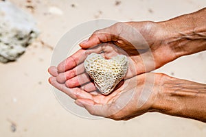 Heart shaped coral in hands, Boracay Island, Philippines