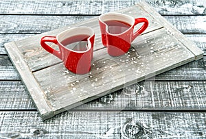 Heart shaped cups red drink rustic wooden background