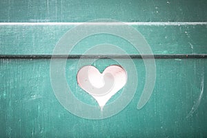 heart shaped cutout in a turquoise shutter