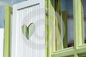 Heart-shaped cutout on window wooden shutter