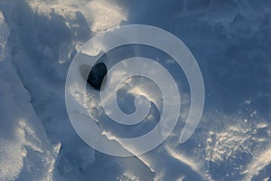 Heart shaped deer hoof print in the snow