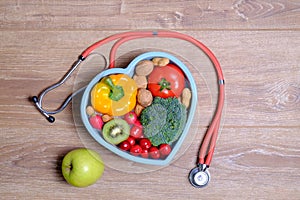 Heart shaped dish with vegetables and stethoscope