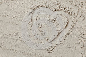 heart shaped drawing on the sand on the beach