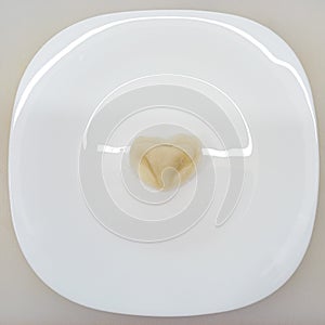 Heart-shaped dumpling on a white plate.