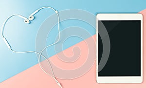 Heart shaped earphone with blank tablet screen