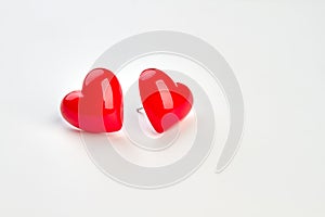 Heart shaped earrings on white background.